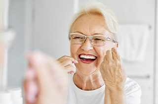 Maintain your oral hygiene to protect your dental implants