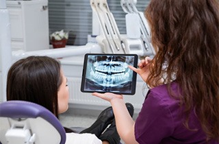 Dentist and patient reviewing X-ray