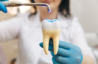 dentist hardening a tooth colored filling 