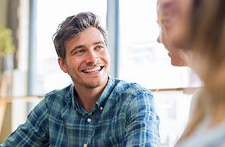 man smiling after getting tooth colored fillings 