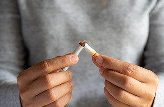 A woman cutting apple slices for her toddler
