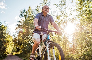 Man in white t-shirt with blue mouthguard outside