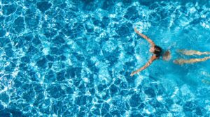 Woman in blue suit swimming in a pool