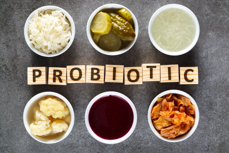 six cups filled with different foods containing probiotics